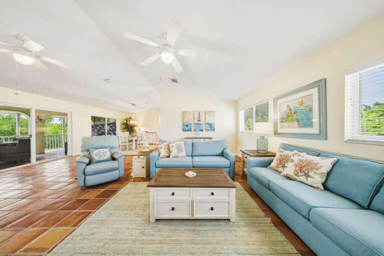 This airy living room opens directly to a screened balcony, creating effortless indoor-outdoor