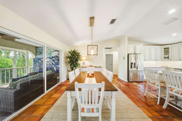 Bright open dining space featuring seating for six and adjacent kitchen counter bar seating, perfect