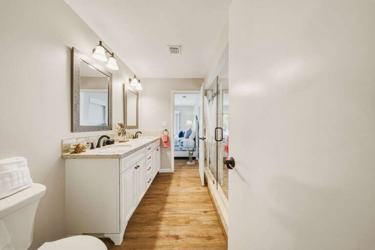 Enjoy a bright and spacious ensuite bathroom with dual vanities and a walk-in shower, offering