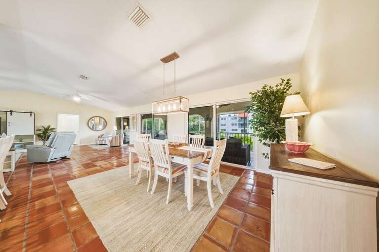 Enjoy waterfront dining with a large dining table and additional breakfast bar seating beside the