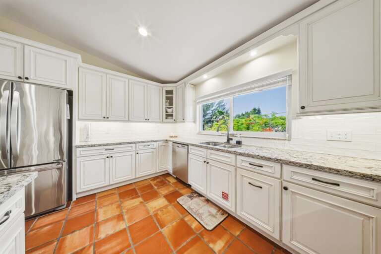 Expansive open-plan kitchen with beautiful water views in a Marathon FL waterfront vacation rental.