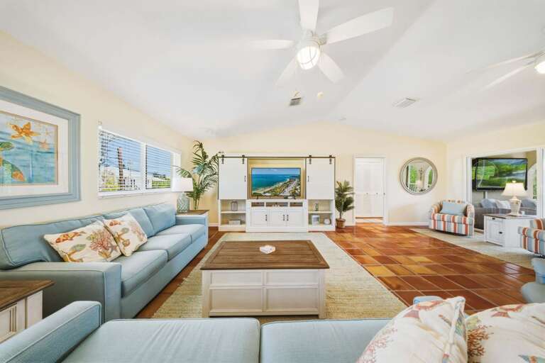 Inviting living space with seamless access to a screened-in balcony overlooking the private pool and