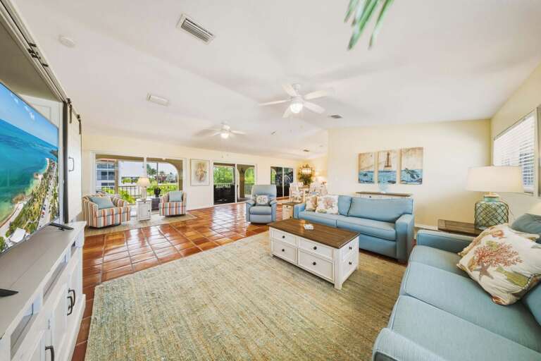 Open-concept living room designed for comfort, with sliding doors that showcase beautiful canal and