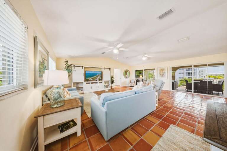 Relax in this spacious living room with direct access to a large screened balcony featuring pool and