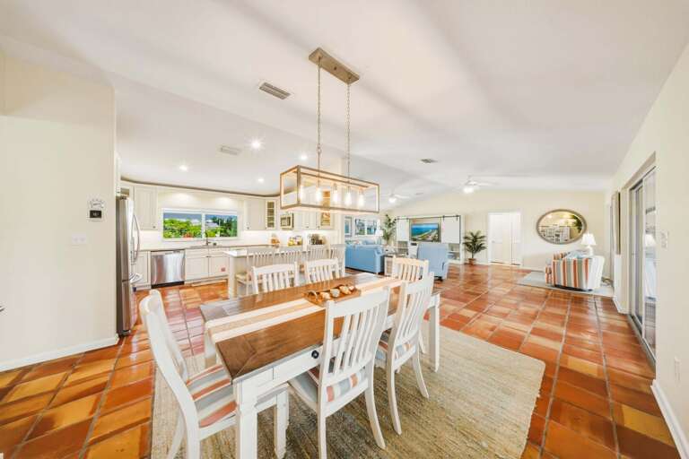 Spacious dining room with table seating for six plus additional bar seating at the kitchen counter