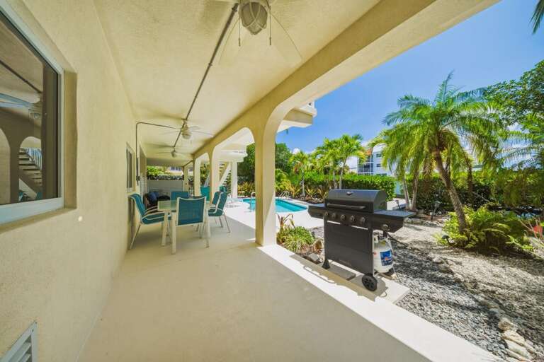Stretch out in the poolside lounge area and enjoy the warm Florida Keys breeze. This waterfront Marathon FL home offers the perfect blend of comfort and outdoor living for your next family getaway.