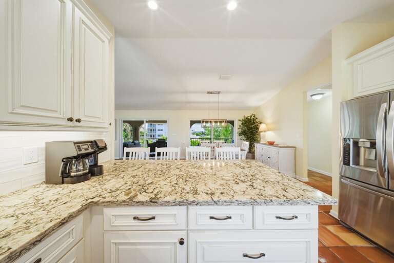 This stylish open kitchen features direct waterfront views and easy access to the dining area,