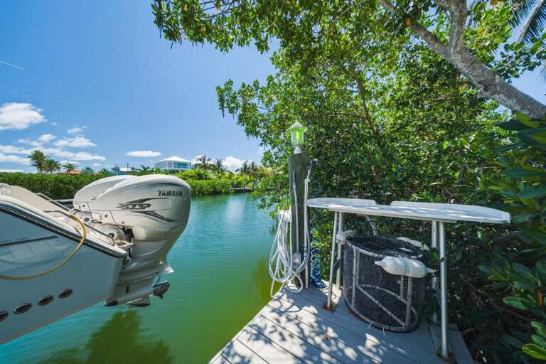 Unwind dockside at this waterfront Marathon FL home, where you can enjoy quiet canal views and fresh ocean air. A perfect complement to your Florida Keys getaway and nearby beach days.