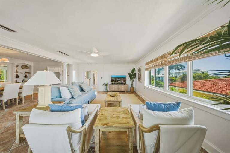 This bright living room offers a large 55” TV, cozy seating, and a welcoming layout for families.
