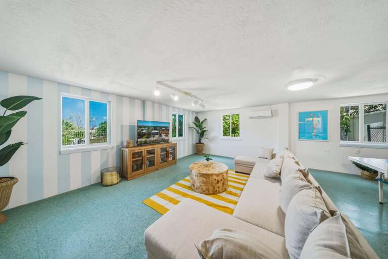 Designed for fun and relaxation, this bonus room features lounge seating, entertainment space, and easy access to outdoor areas.