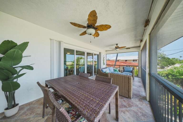 Enjoy an inviting outdoor living area with seating and dining space, perfect for gathering with family and friends in your Marathon FL Florida Keys getaway.