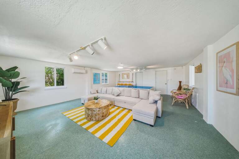 Enjoy a private downstairs bonus room with a large TV, comfortable seating, and space to unwind. Perfect for movie nights or relaxing after a day at Sombrero Beach during your Florida Keys getaway.