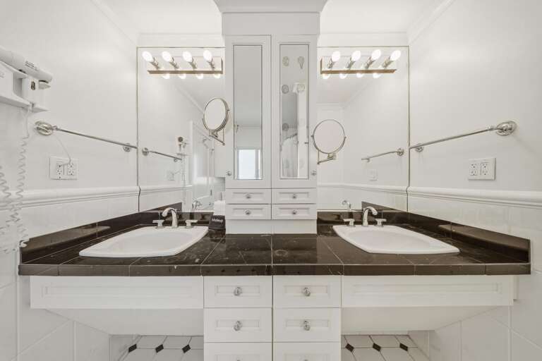 This ensuite bathroom features dual vanities and a tub/shower combo, offering convenience and comfort for your Marathon FL stay.
