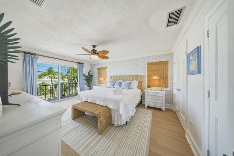 Retreat to the master suite featuring a king bed, private balcony access, and blackout curtains for restful nights during your Marathon FL getaway.