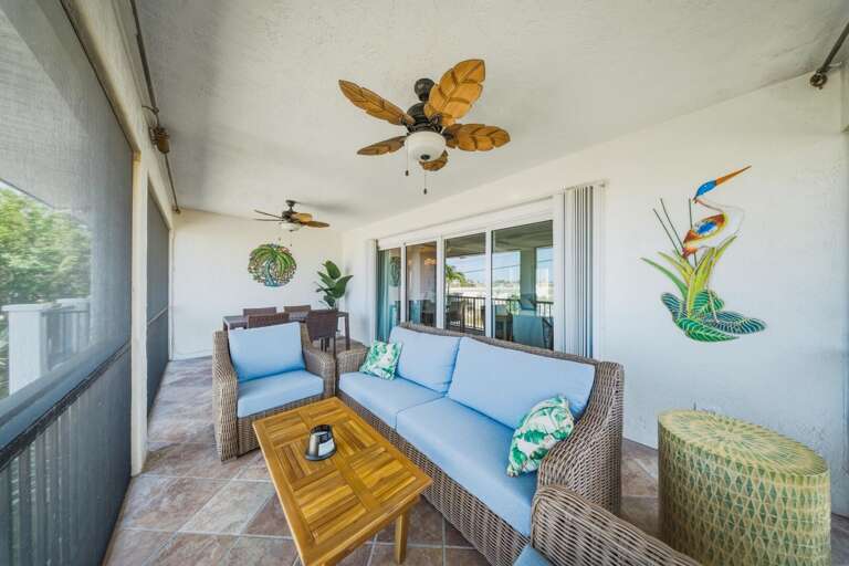 This screened porch offers shaded comfort and outdoor seating, ideal for morning coffee or evening relaxation during your Marathon Florida Keys vacation.