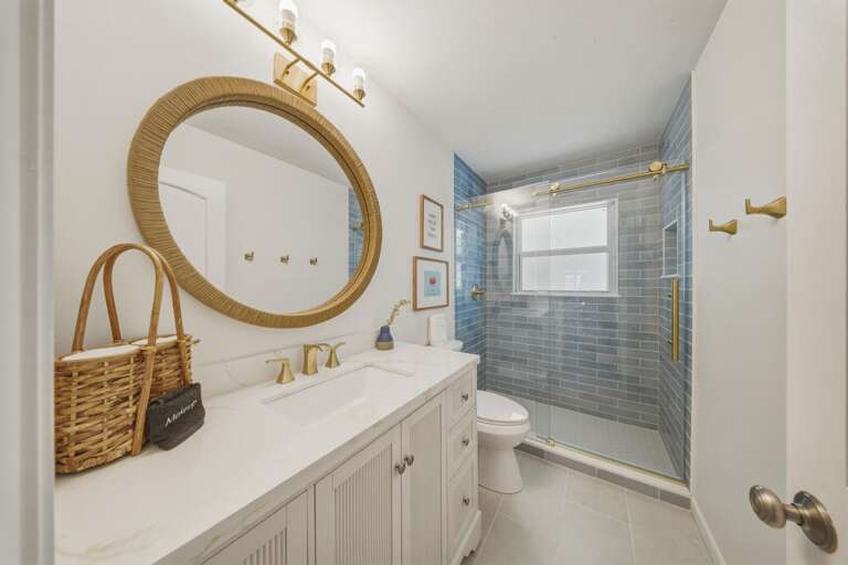 This updated guest bathroom features a walk-in shower and modern finishes for your Marathon FL stay.