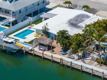 This 3-bedroom, 2-bath Key Colony Beach half-duplex offers private dockage, a tiki hut, kayaks, pet-friendly accommodations, and Cabana Club access for a true Florida Keys getaway.