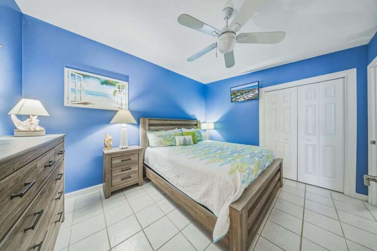 This guest bedroom features a king bed and cable TV, offering a comfortable and inviting space for additional guests during your Florida Keys stay.