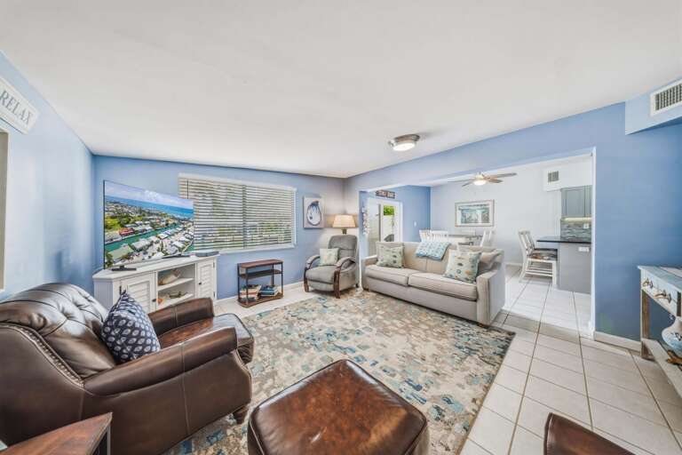 The living room offers a comfortable gathering space with a large Smart TV and plenty of room to relax after a day boating, fishing, or enjoying the Cabana Club.