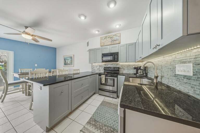 Prepare breakfast before a day on the water or enjoy a relaxed dinner at home in this bright, functional kitchen at your Key Colony Beach Florida Keys getaway.