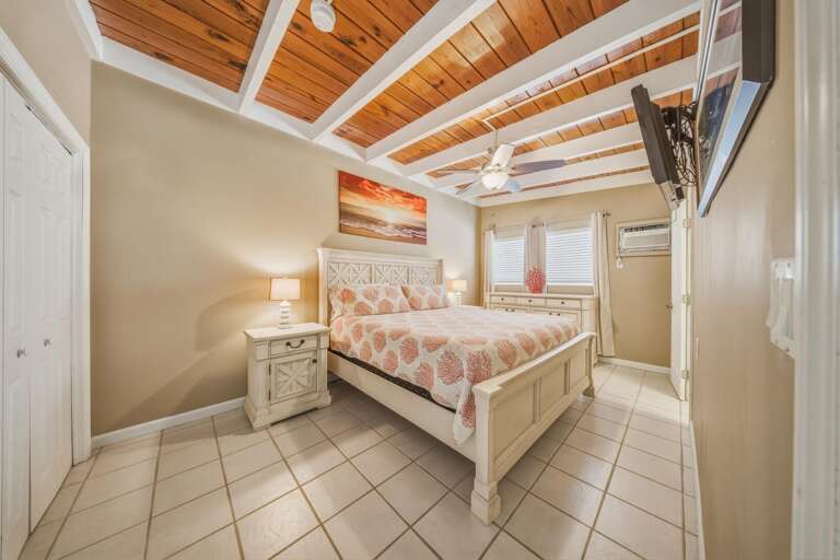 The primary suite features a king bed and private en suite bathroom, creating a relaxing retreat for your stay in Key Colony Beach.