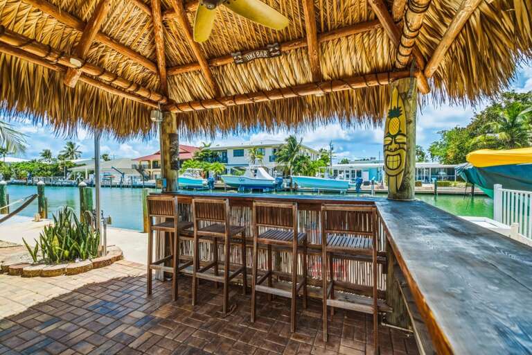 Relax under the private tiki hut overlooking the canal, complete with bar seating and a shaded outdoor space designed for laid-back Keys living.
