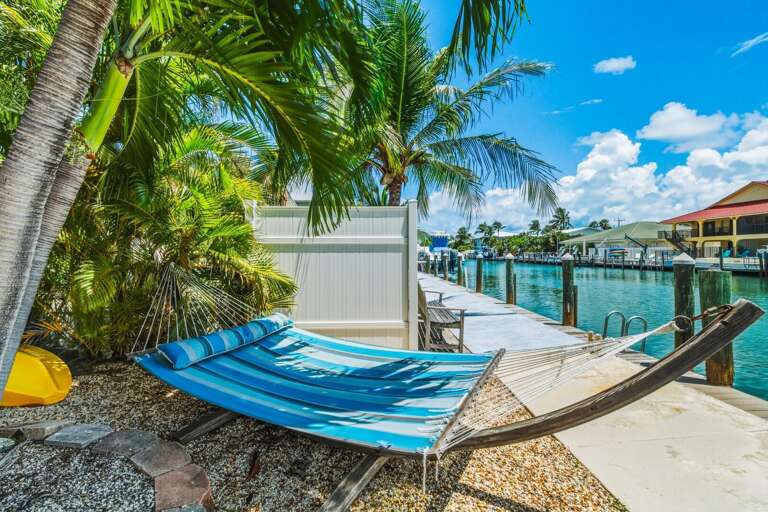 Unwind in the backyard hammock and enjoy the peaceful canalfront setting, tropical landscaping, and relaxed pace of life in Key Colony Beach.