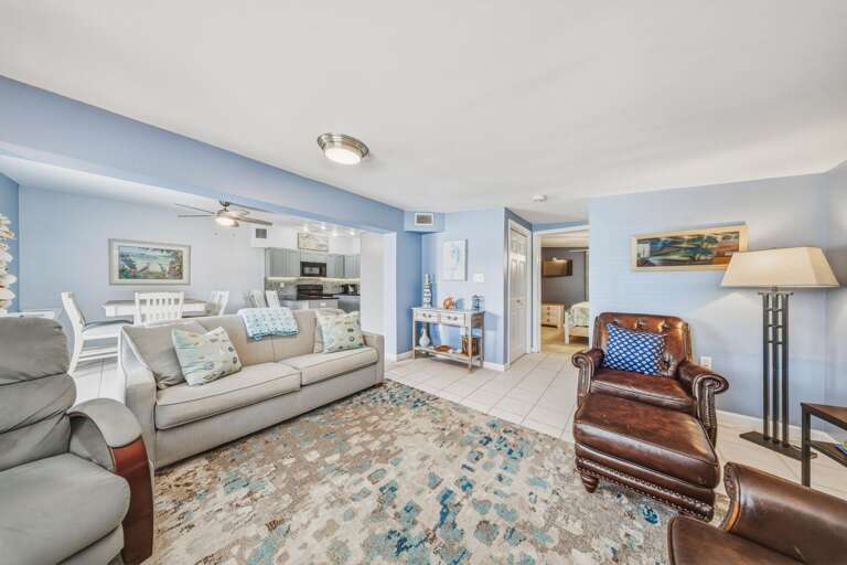 Unwind in the bright and welcoming living area, complete with a large Smart TV and easy access to the kitchen, dining space, and outdoor canalfront amenities.