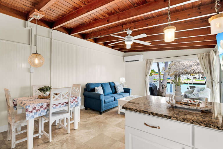 The open living and dining area creates an easy gathering space for meals, movie nights, and relaxing between days spent on the water in Key Colony Beach.