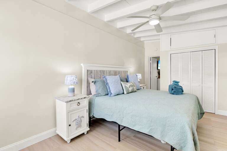 The primary bedroom offers a comfortable king bed and peaceful retreat after a day of boating, fishing, beach time, or relaxing at the Cabana Club.