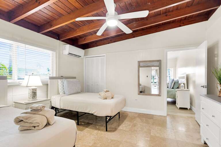 The twin bedroom connects to the primary bedroom area, offering a practical layout for families or close groups staying together in Key Colony Beach.
