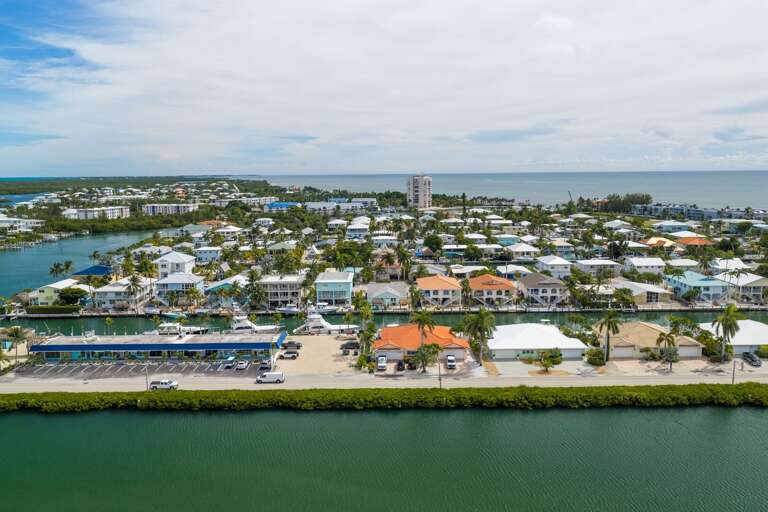 This elevated view captures the surrounding canals, tropical neighborhood, coastline, and central Marathon location.