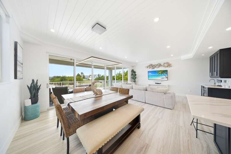 Enjoy shared meals beside large windows offering natural light and peaceful views of the Marathon waterfront.