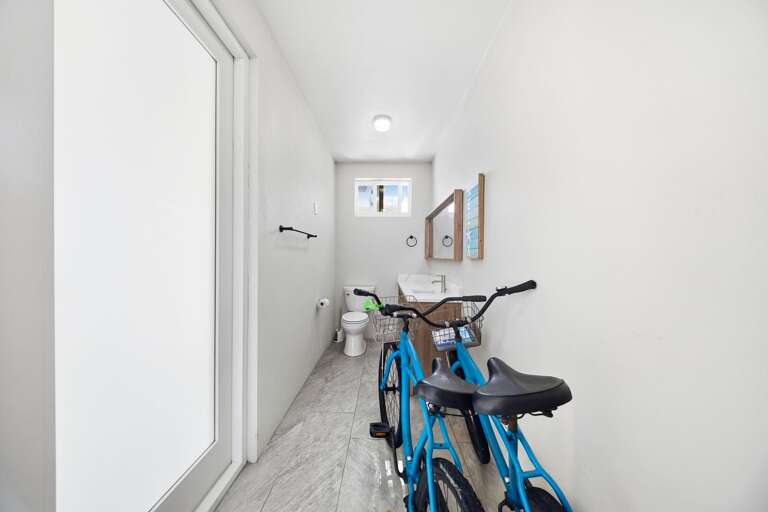 This conveniently located half bathroom includes a toilet and provides easy access from the home's outdoor areas. Bicycles are available for exploring the neighborhood