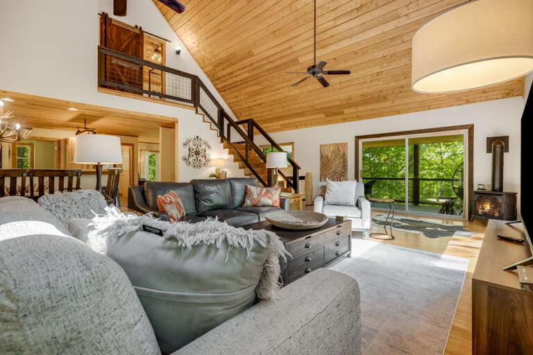 Living Area w/ Covered Deck Access & Wood Stove