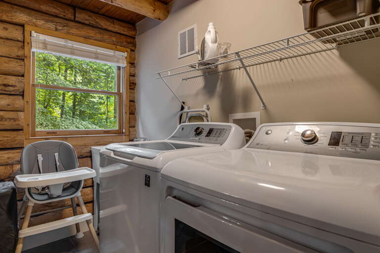 Full-size washer and dryer make it easy to keep your family fresh during your stay, while the charming log cabin walls and forest view add rustic warmth.