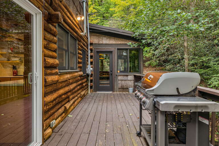 This charming log cabin retreat sits nestled among lush greenery, offering a peaceful woodland escape. Fire up the grill on your private deck and breathe in the fresh forest air.