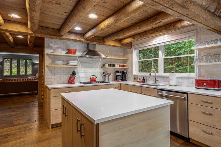 Step into this beautifully designed kitchen where rustic charm meets modern convenience. The exposed wood beams and natural light create a warm, inviting atmosphere as you prepare your favorite meals.