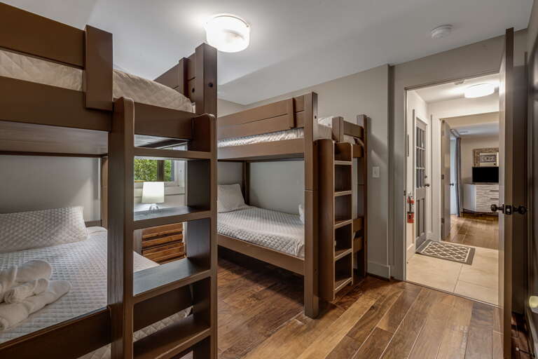Your group can rest easy in this cozy bunk room, where crisp linens and sturdy wooden bunks create a comfortable retreat after a day of adventure.