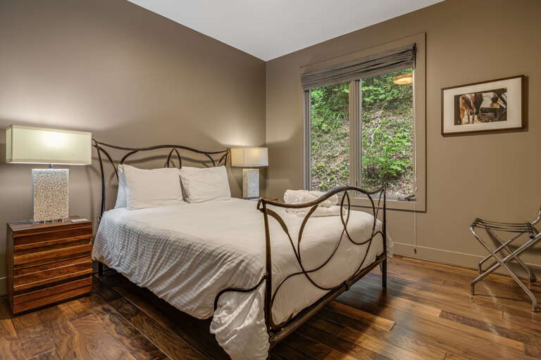 Sink into crisp linens and wake to a peaceful garden view. Your stylish retreat features warm wood floors, elegant decor, and natural light to help you unwind completely.