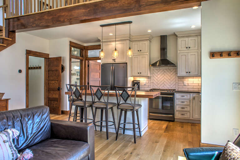 Kitchen w/ Breakfast Bar Seating & Stainless Steel Appliances