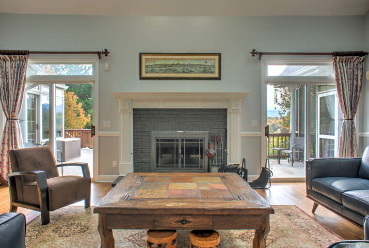 Living Area w/ Wood Burning Fireplace & Deck Access Living Area w/ Wood Burning Fireplace & Deck Access