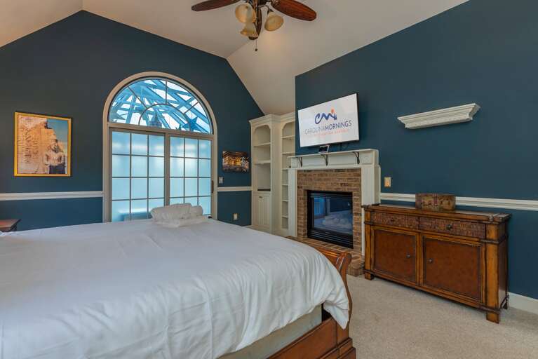 Main Suite/Bedroom One - Smart TV, Aesthetic Fireplace, & Access to Solarium