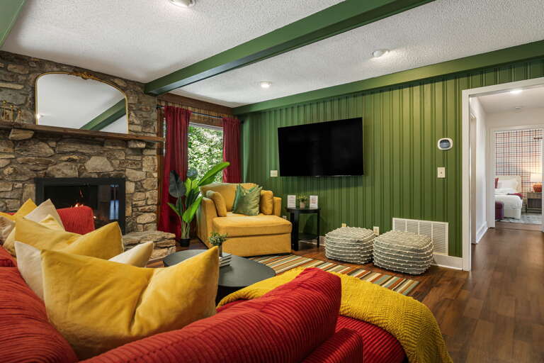 Main Level - Living Area w/ Wood Fireplace & Smart TV