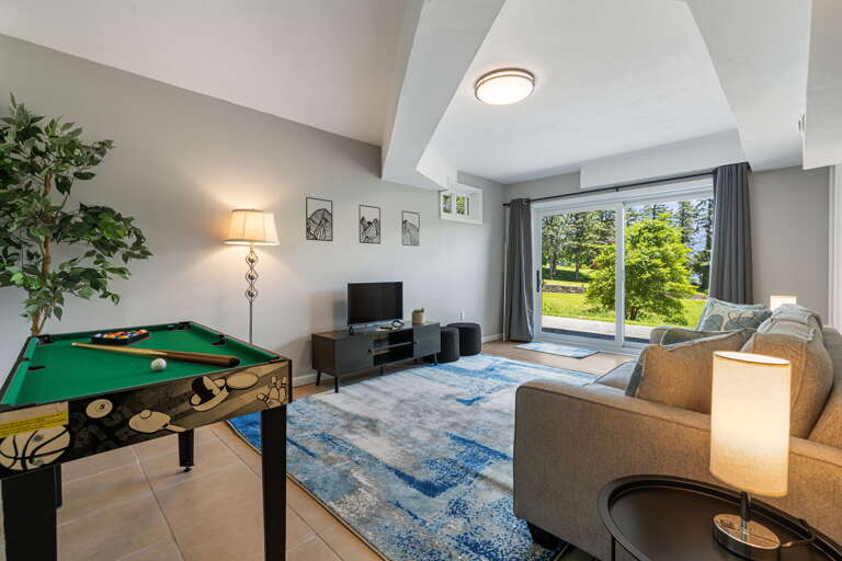 Lower Level - Living Area w/ Mini-Pool, Smart TV, & Patio Access