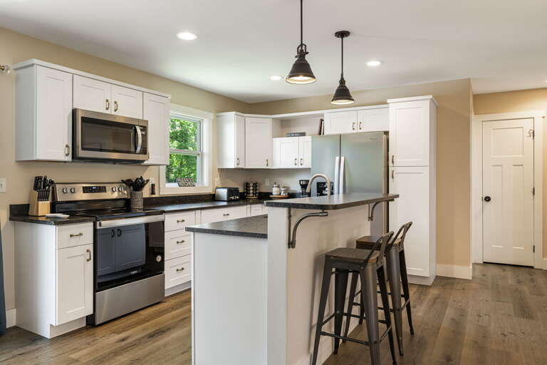Fully Equipped Kitchen w/ Breakfast Bar Seating and Stainless Steel Appliances