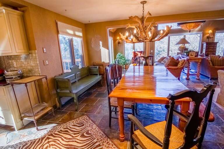 Spacious Dining Space With Sunset Shades, Shimmering Surfaces, And Sleek Seating