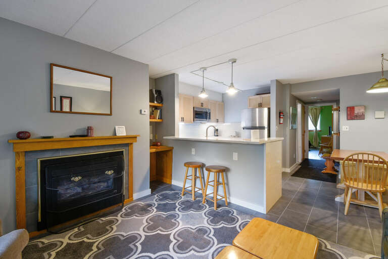 Interior Living Space Featuring Fireplace, Kitchen Island, And Dining Area