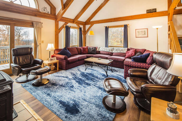 Spacious Living Room With Plush Sofas And Vaulted Ceiling In Vacation Rental