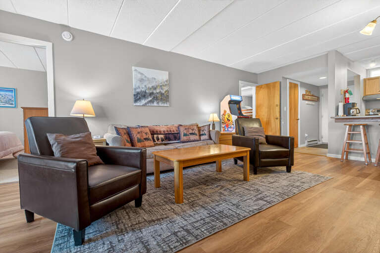 Spacious Living Space With Leather Loungers And Light Flooring